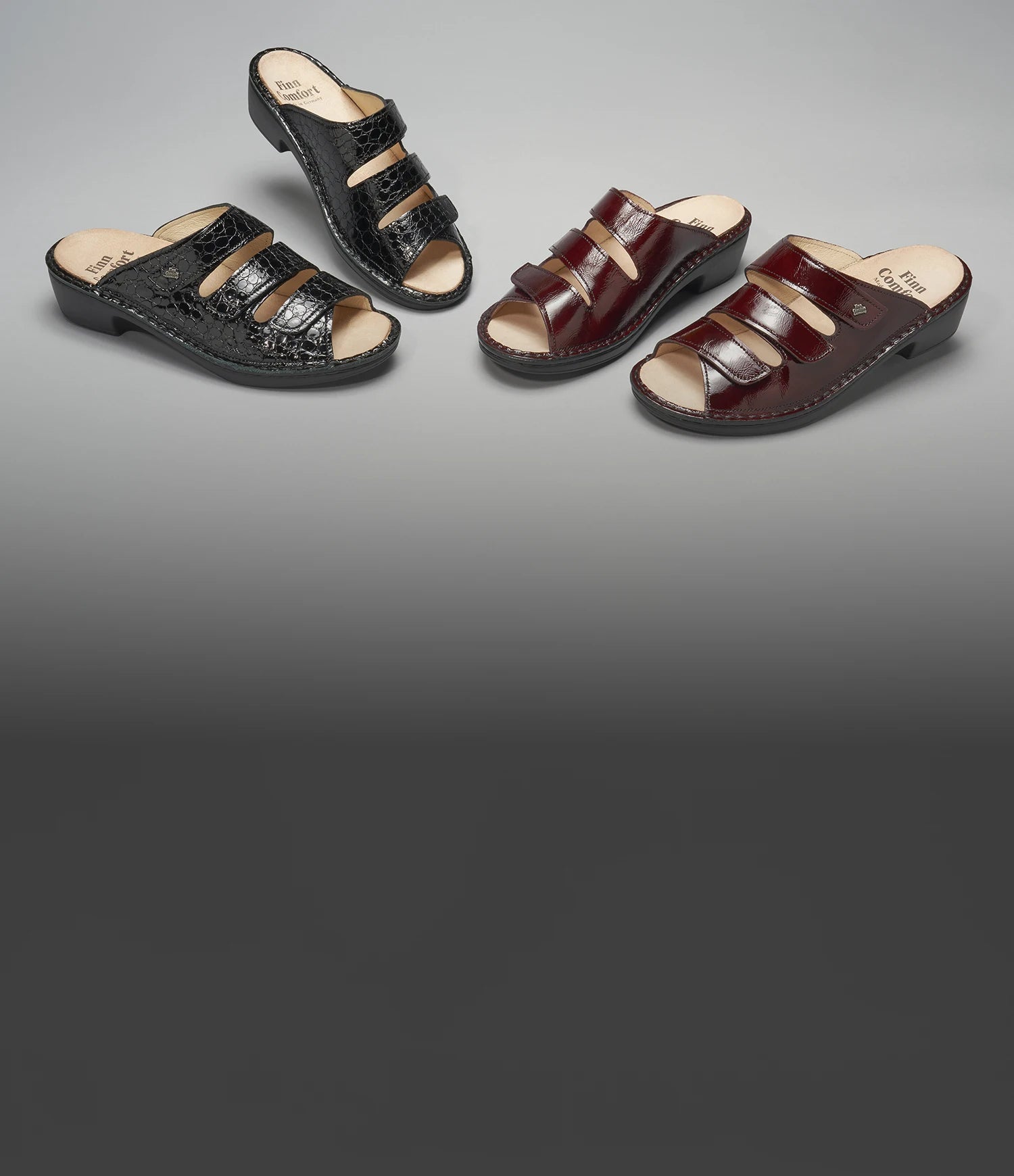 Still life di cabatte Canzo Finncomfort in pelle vernice bordeaux e pelle rettile nera su sfondo grigio