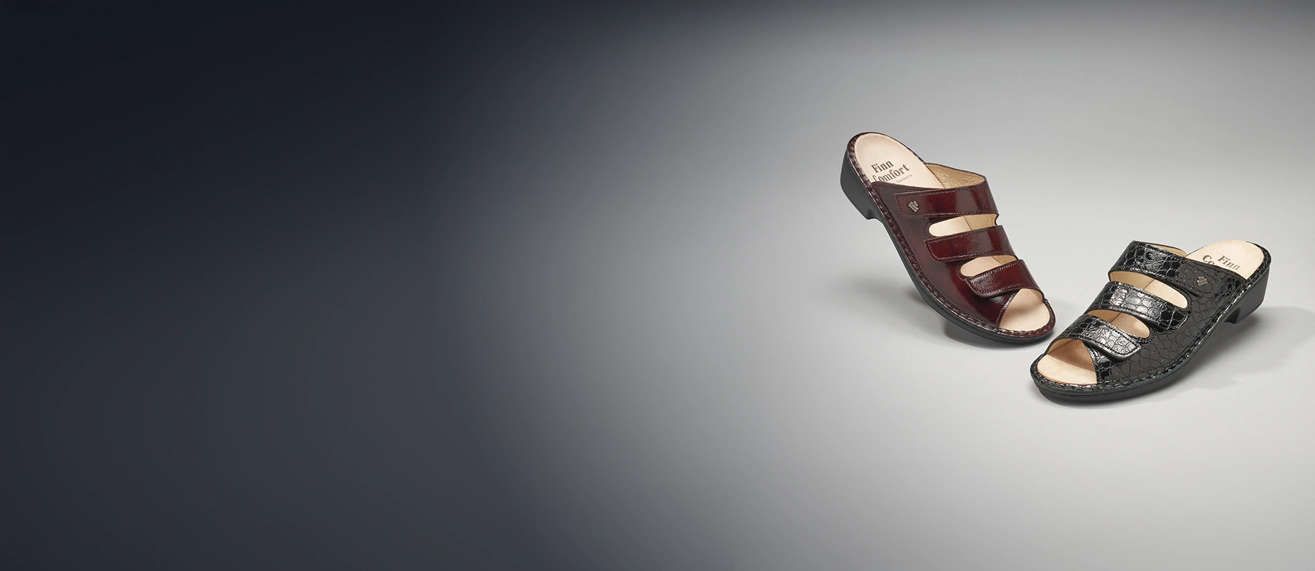 Primo piano di ciabatte anatomiche Finncomfort modello Canzo in pelle vernice bordeaux e pelle rettile nera